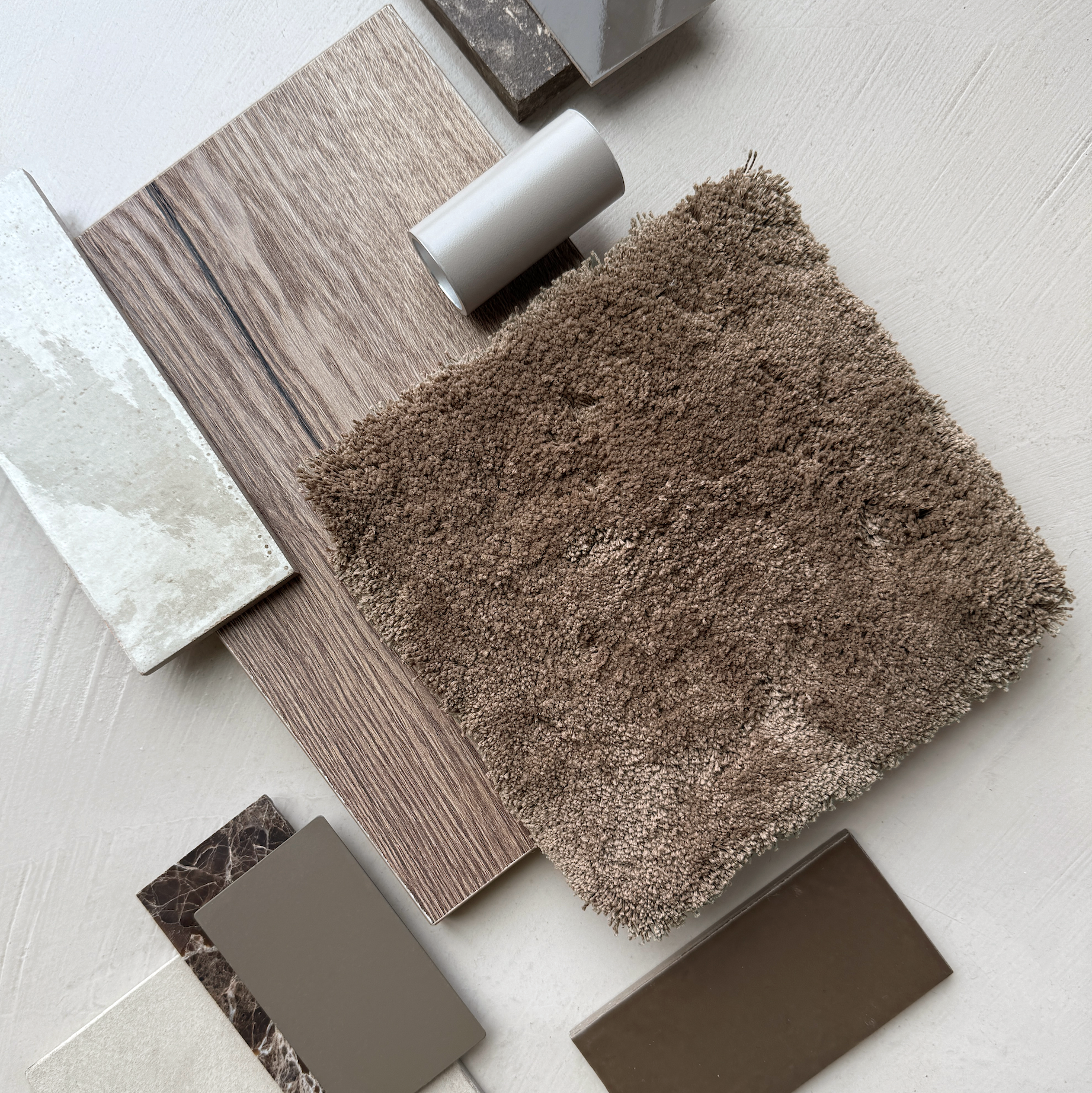 Collection of brown and beige textured samples on a light surface